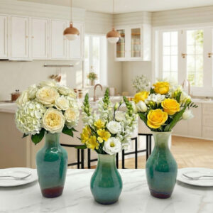 KeyDeco Small emerald green ceramic bud vase holding fresh flows on a kitchen table